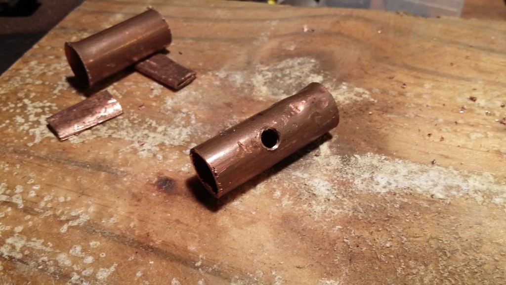 Drilled and tapped a M6 thread into the side of the pipe and bent over the tube halves to make electrodes